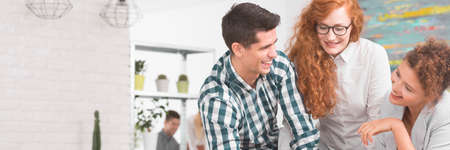 Colleagues from work talking at laughing during a meeting