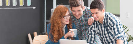 Young people wearing casual clothes working together in creative office