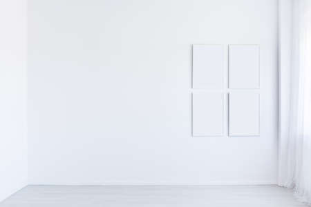 Mockup of white posters gallery in white autistic child's empty room, copy space interior concept