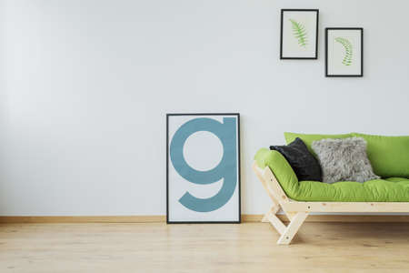 Minimalist interior design of modern loft with mock-up poster, wooden floor, white wall and green...