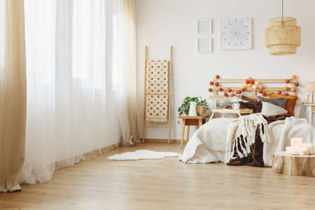 Interior of a spacious bedroom in scandinavian style with candlesの写真素材