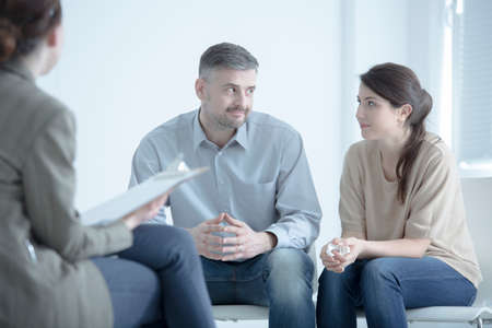 Marriage trying to reconcile while talking to each other during marriage therapy with mediatorの写真素材