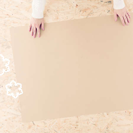 Female hands and eco-friendly wrapping paper on tableの写真素材