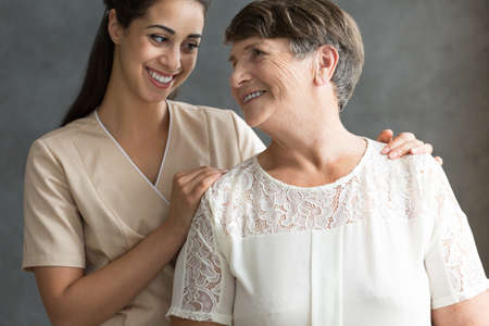 Smiling senior lady is happy because her family taking care about her during retirementの写真素材