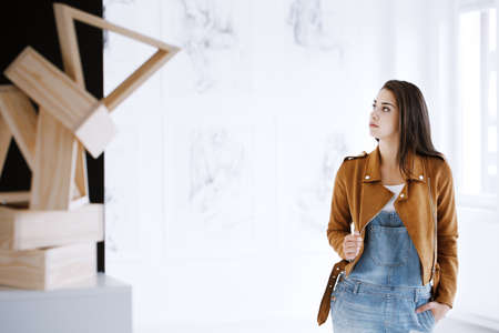 Student of art visiting a museum featuring a new exhibition of sculptures and paintings