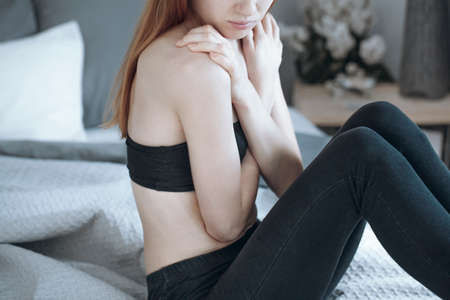 Close-up of teenage girl hate yourself because of obsession to loss weight and anorexia problemの写真素材