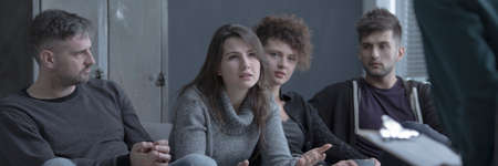 Mourning lady with depression confiding during support group therapyの写真素材