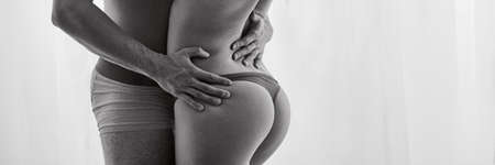 Couple of lovers with beautiful bodies embracing each other during sex meetingの写真素材