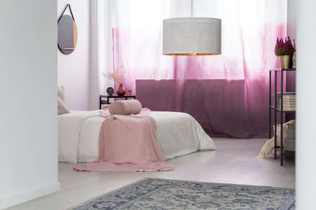 White Lamp Above Grey Carpet In Bedroom With Pink Curtains And