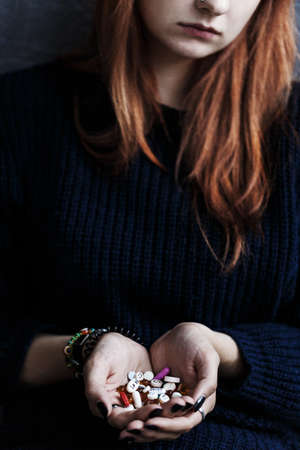 Close-up of teenager's hands with drugs. Drug addiction of young person conceptの写真素材