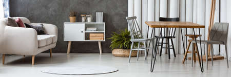 White round rug lying on the floor of modern apartment designed in scandinavian style