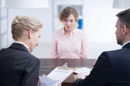 Headhunters looking at references of a young candidate for a job position