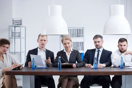 Professional businesswomen and businessmen listening to entrepreneur applying for subsidies for the...
