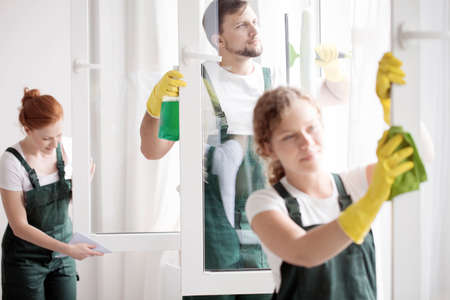 Skilled cleaning team washing the windows. Home cleaning service conceptの写真素材