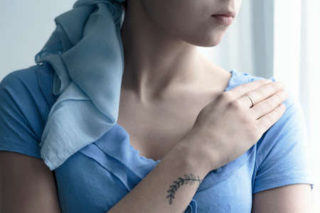 Close-up of a person with an arm tattoo during chemotherapyの写真素材