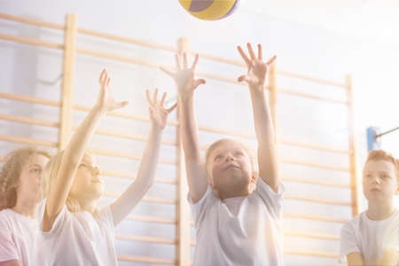 Low angle of active children playing volleyball during physical education classes
