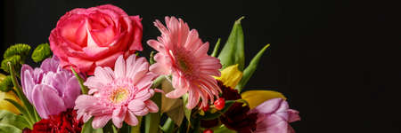 Close-up photo of colorful fresh flowers bouquet for Valentine's Day on dark backgroundの写真素材