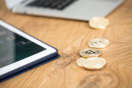 Close-up of gold cryptocurrency coins on table. Investing on the internetの写真素材