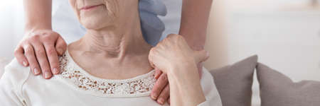 Close-up of a person helping an elderly woman with breast cancerの写真素材