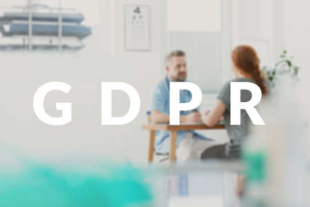 GDPR in doctor's office concept. Surgeon talking to his patient about personal data protection...