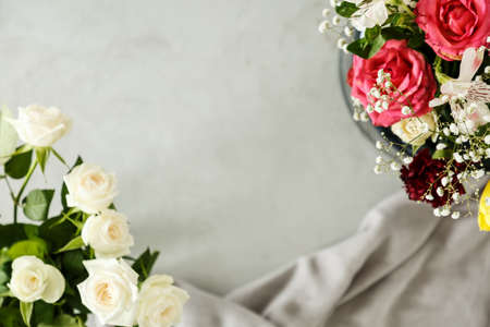 White and red roses against grey background. Mother's day occasional card with copy spaceの写真素材