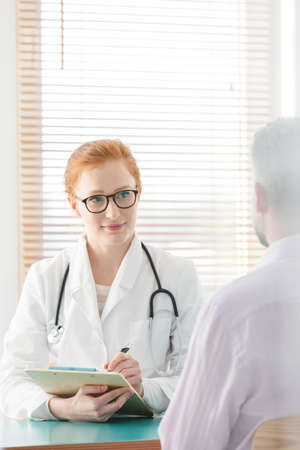 Doctor in white uniform and stethoscope during consultation in the hospitalの写真素材