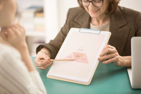 Close-up of smiling life coach talking about balance between the body, mind and spirit with client
