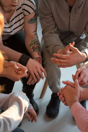 High angle on difficult young people during meeting of support groupの写真素材