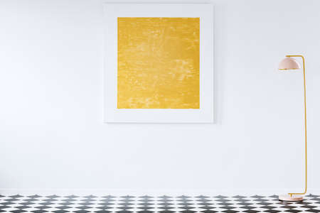 Orange painting on white wall in minimal living room interior with lamp and checkerboard floor. Place for your furnitureの写真素材