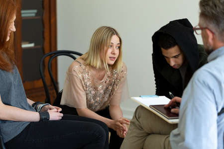 Teenage girl talking to a psychologist during meeting of support group