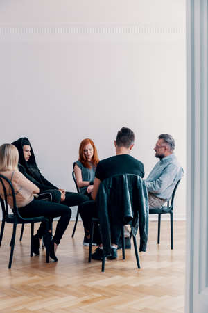Rebellious teenagers and psychologist sitting in a circle during group therapyの写真素材