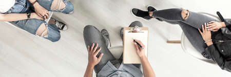 Top view of rebellious teenagers during therapy with psychologistの写真素材
