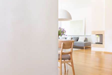 White empty wall with copy space in living room interior with chair and wooden floor. Real photo...
