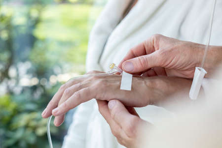 Close-up of a hand with a peripheral venous access catheter