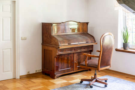 Classic piano and chair on wheels in an antique room interior. Real photoの写真素材