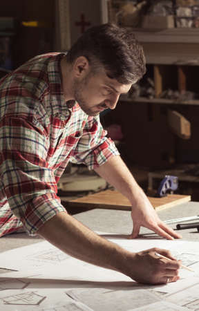 Contractor drawing a project for building a house