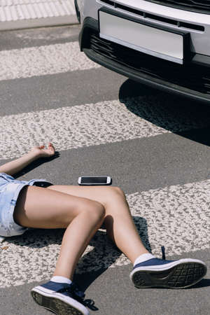 The car hit a child with smartphone on a pedestrian crossing