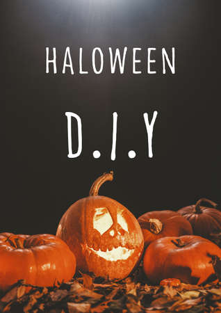Halloween poster with text, moon light, carved pumpkin with happy face and autumn leavesの写真素材