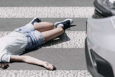 High angle on a child on a crosswalk hit by a carの写真素材