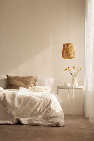 Natural material in bedroom, real photo with copy space on the empty wallの写真素材