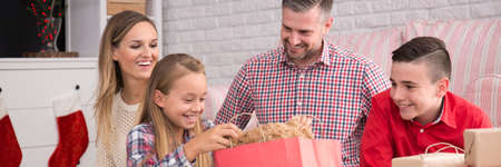 Parents looking at their children with presentsの写真素材