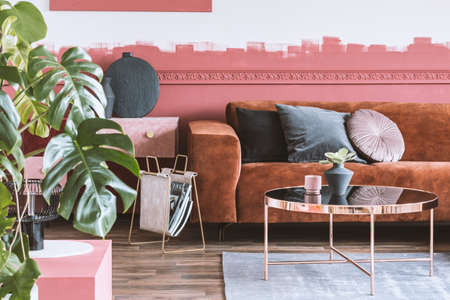 Trendy living room with ombre wall and brown velvet corner sofa with pillowsの写真素材