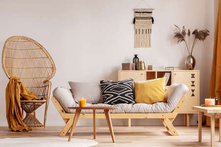 Wicker peacock chair in elegant living room interior
