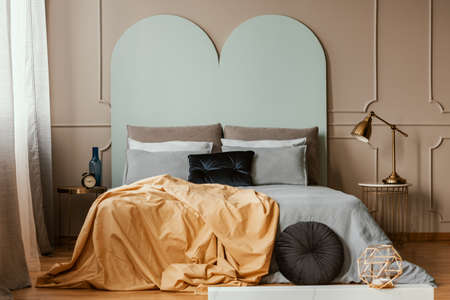 Pastel blue headboard of king size bed with cozy bedding and pillowsの写真素材
