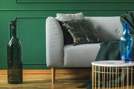 Close-up of gray sofa in green living room interiorの写真素材