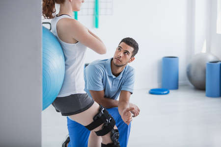 Professional personal trainer and sportswoman exercising with ballの写真素材