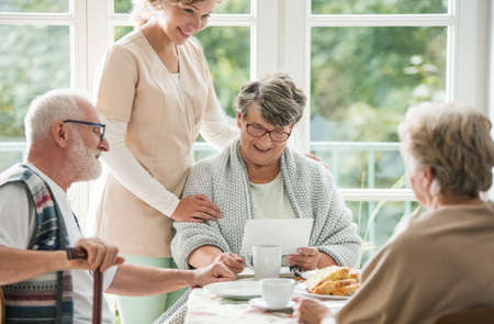 Senior friends spending time together at nursing homeの写真素材