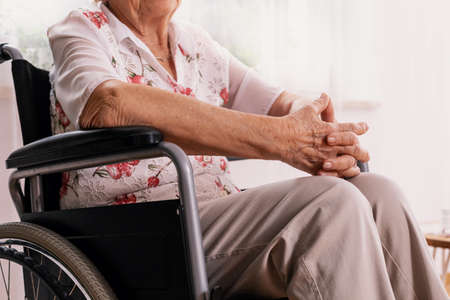 Elderly woman sitting on wheelchair at nursing home