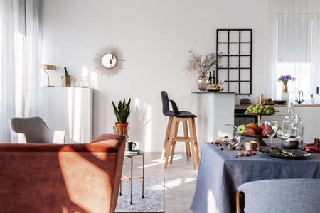 Open plan kitchen and dining room interior idea with white furnitureの写真素材