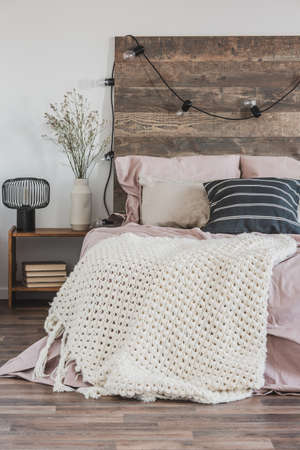 Beautiful bedroom interior with king size bed wooden headboard